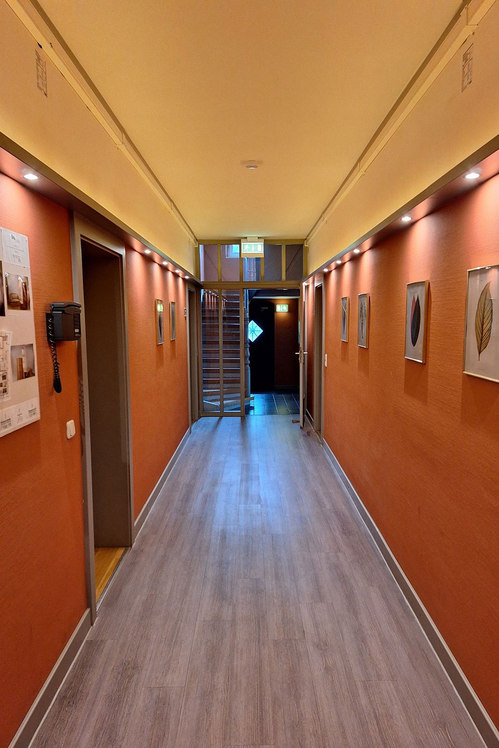 View of a corridor with orange walls.