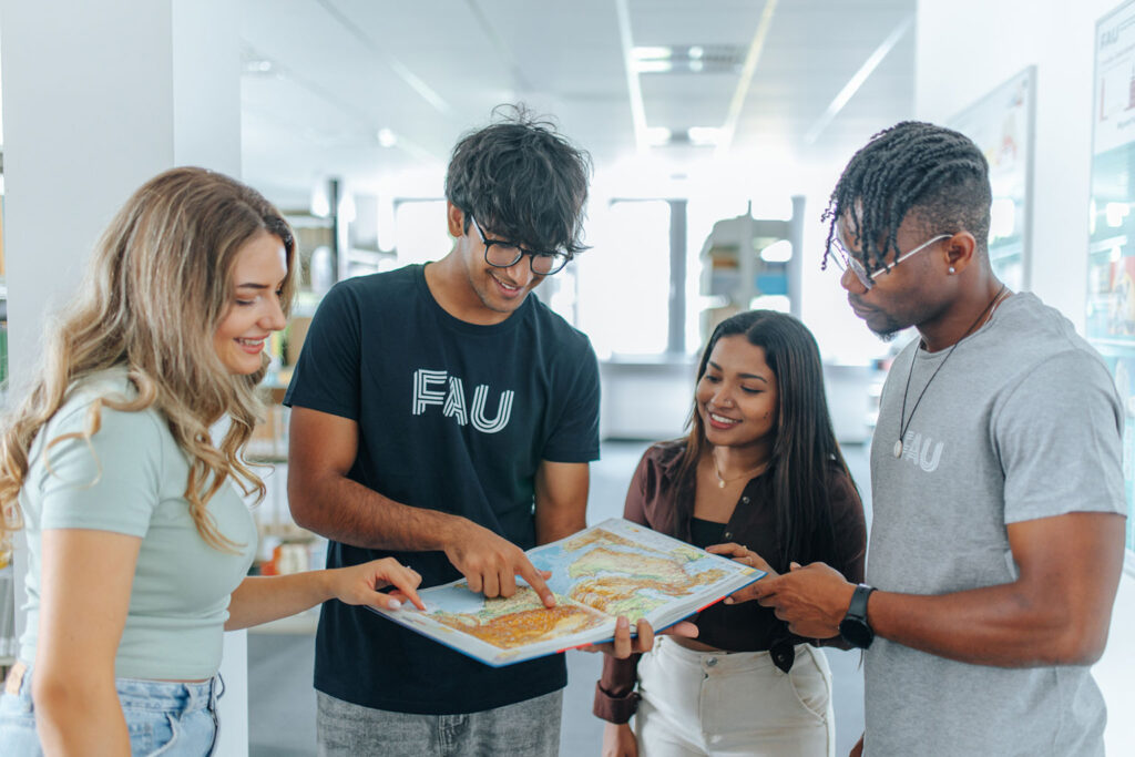Students look at an atlas together.