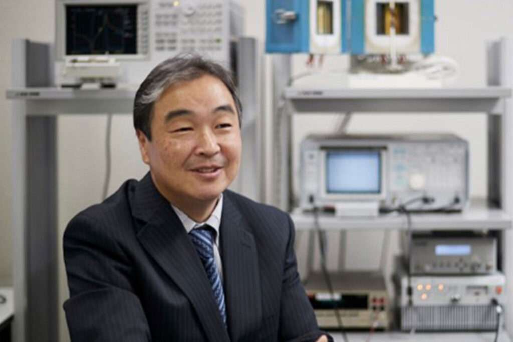 Photo of Ken-ichi Kakimoto sitting in a laboratory.